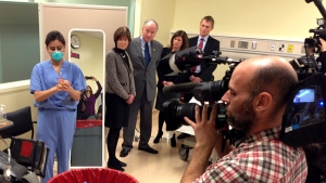 From left, Judith Bossé, assistant deputy minister of health, Defence Minister Rob Nicholson, Health Minister Rona Ambrose and Chief Public Health Officer Dr. Gregory Taylor watch a health-care worker demonstrate the use of protective equipment to prevent infection from the Ebola virus, at an Ottawa hospital Thursday. (Catherine Cullen/CBC)